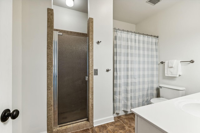 bathroom with vanity, toilet, walk in shower, and tile patterned floors