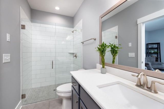 bathroom with toilet, tile patterned flooring, walk in shower, and vanity