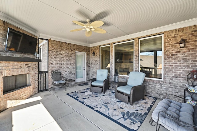 view of patio featuring ceiling fan and an outdoor brick fireplace