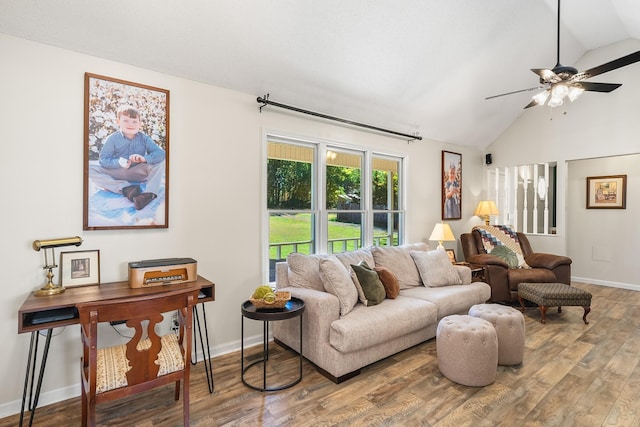 living room with ceiling fan, wood-type flooring, and lofted ceiling