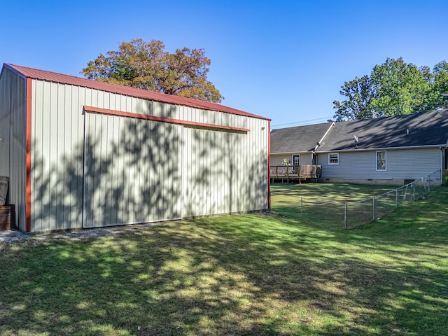 view of yard with a deck and an outbuilding