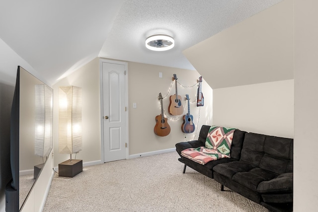 living area featuring lofted ceiling, a textured ceiling, and carpet