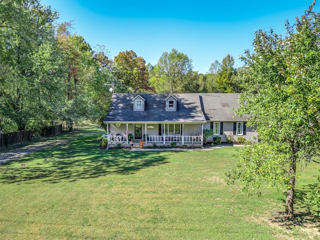 rear view of house with covered porch and a yard