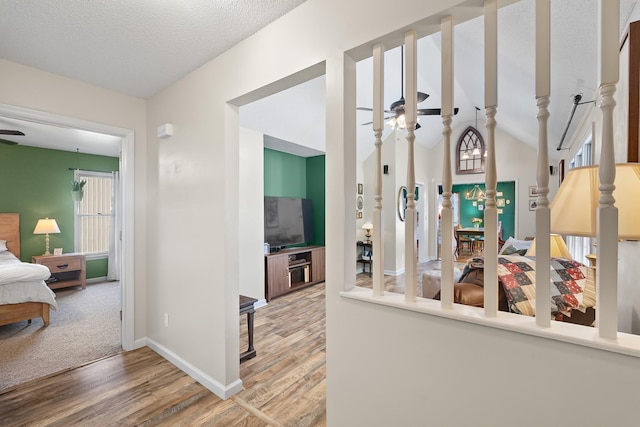 hall with a textured ceiling and hardwood / wood-style floors