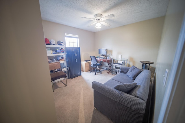 carpeted office with ceiling fan and a textured ceiling