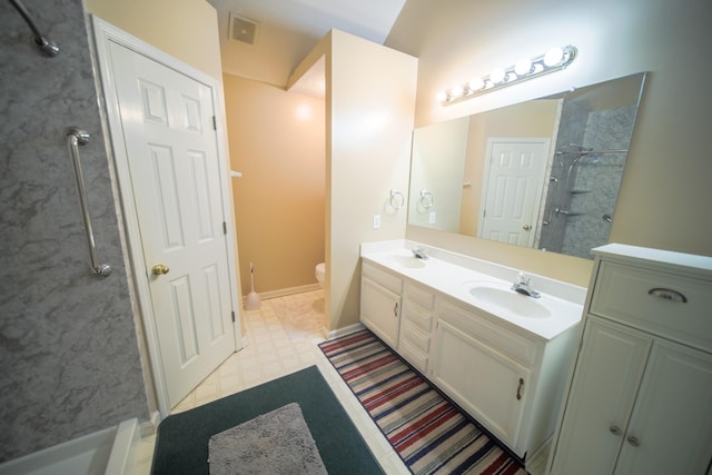 bathroom with a shower, toilet, and vanity