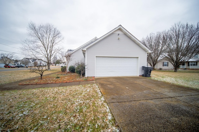 view of property exterior featuring a garage and a yard