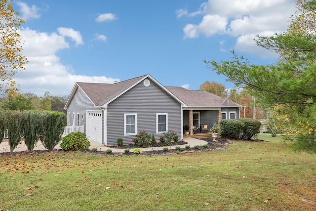 view of front of home featuring covered porch, a front yard, and a garage