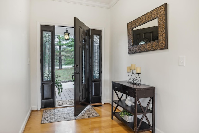 entrance foyer featuring hardwood / wood-style flooring and ornamental molding