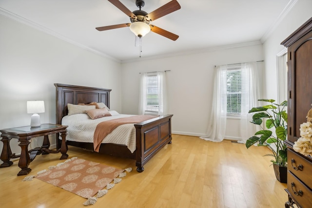 bedroom featuring ceiling fan, ornamental molding, and light hardwood / wood-style floors