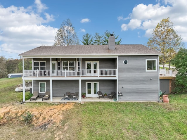 back of property with a patio area, a yard, an outdoor hangout area, and french doors