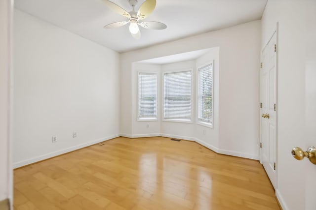 unfurnished room with ceiling fan and light hardwood / wood-style floors