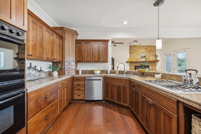 kitchen with dark hardwood / wood-style flooring, sink, decorative light fixtures, ornamental molding, and stainless steel appliances