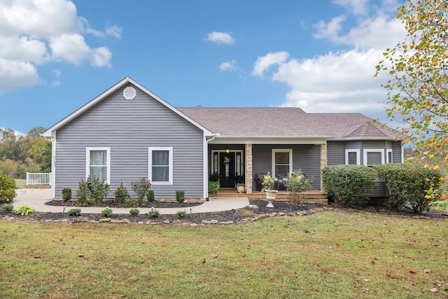 single story home featuring covered porch and a front yard