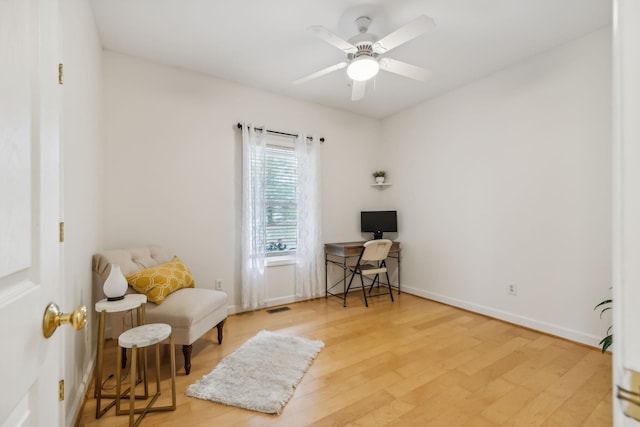 living area with hardwood / wood-style flooring and ceiling fan