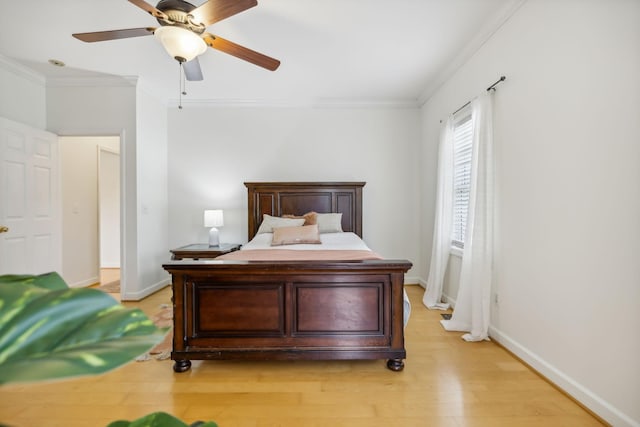 bedroom with crown molding, light hardwood / wood-style flooring, and ceiling fan