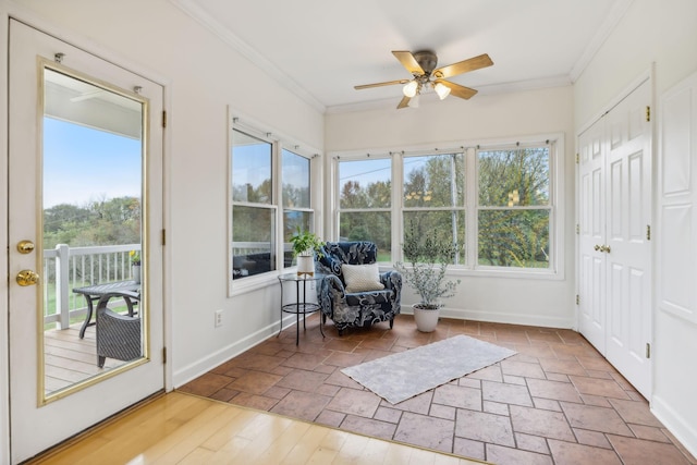 unfurnished sunroom with ceiling fan