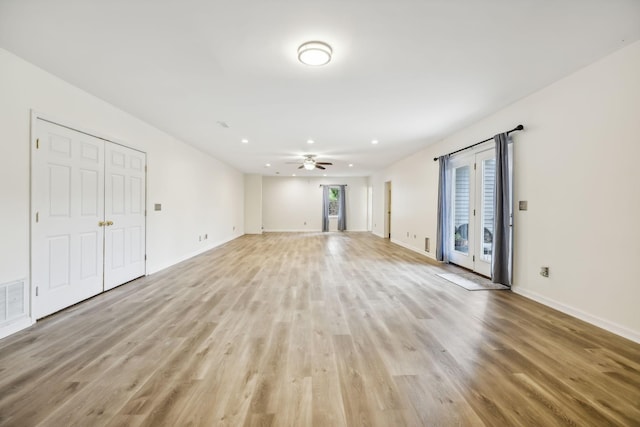 unfurnished living room featuring ceiling fan and light hardwood / wood-style flooring