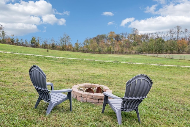 view of yard with a fire pit and a rural view