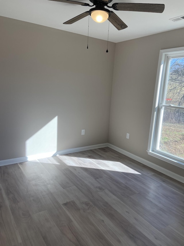 unfurnished room with wood-type flooring and ceiling fan