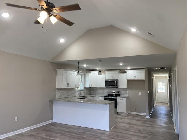 kitchen with decorative light fixtures, stainless steel appliances, kitchen peninsula, and white cabinets