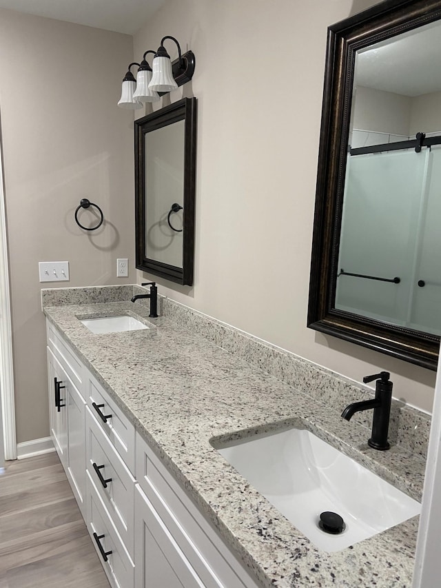 bathroom featuring vanity and hardwood / wood-style floors