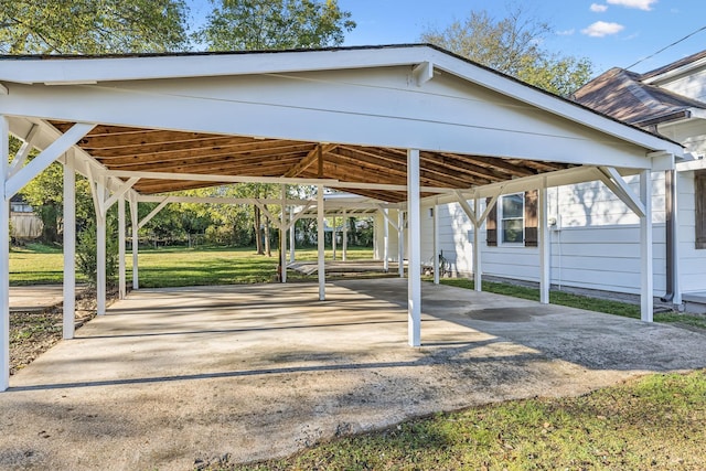 view of parking featuring a lawn and a carport