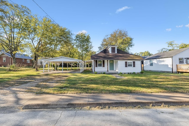 view of front facade with a front yard and a carport