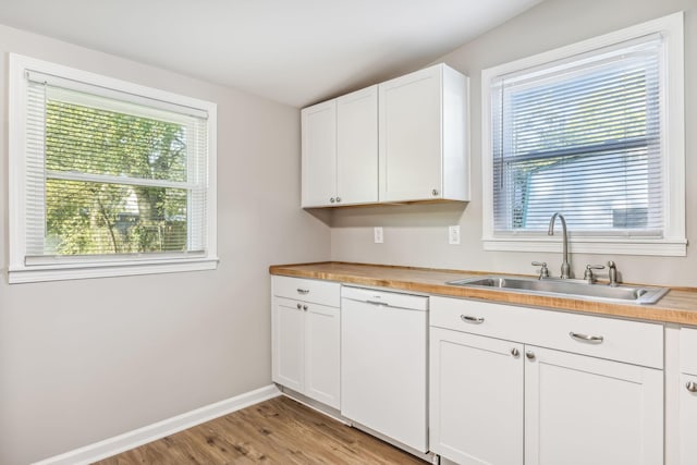 kitchen featuring sink, white cabinets, dishwasher, and plenty of natural light