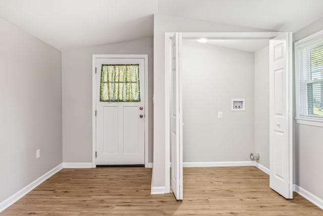 foyer entrance featuring light hardwood / wood-style floors and vaulted ceiling