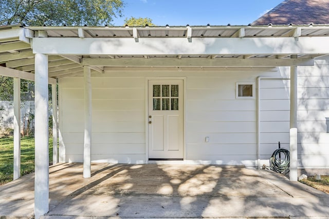 view of exterior entry featuring a carport