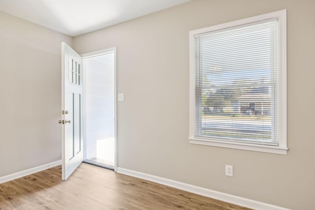 spare room with light hardwood / wood-style floors and a wealth of natural light