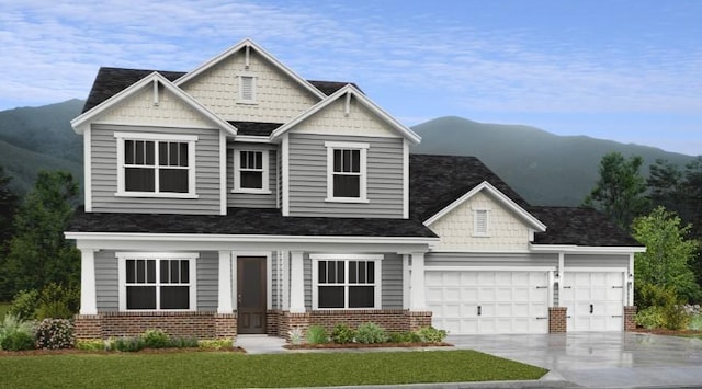 craftsman-style home featuring a mountain view, a front lawn, and a garage