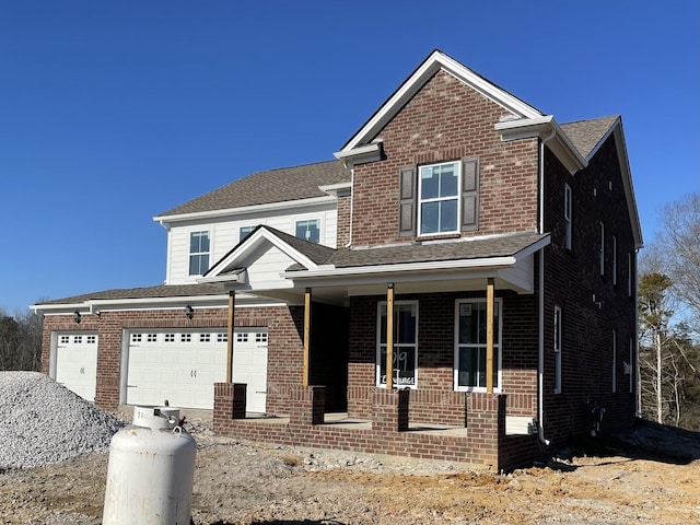 view of front of home featuring a garage and covered porch