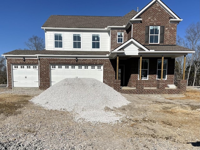 front facade with a garage and a porch