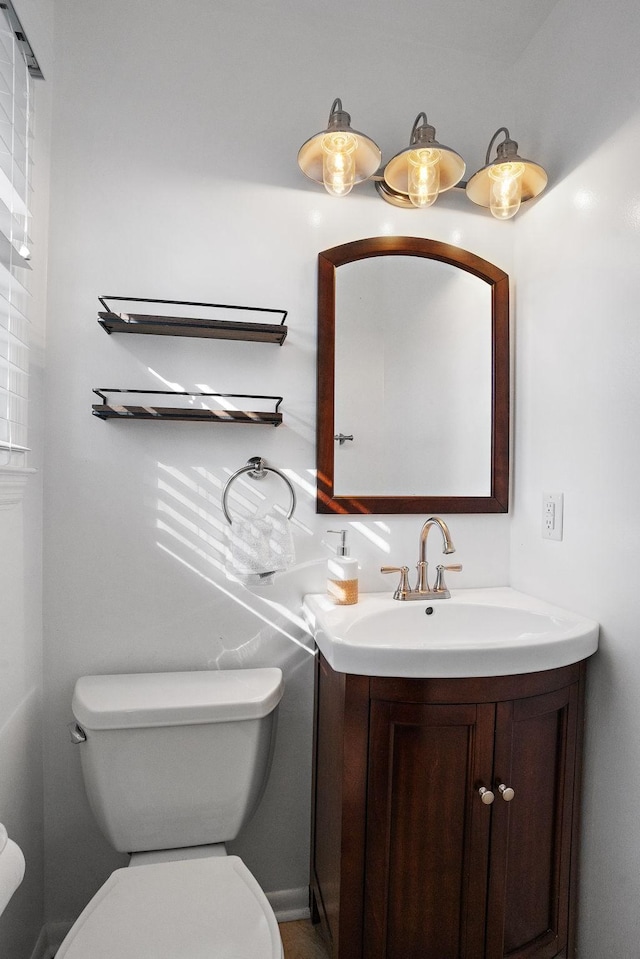 bathroom with toilet and vanity