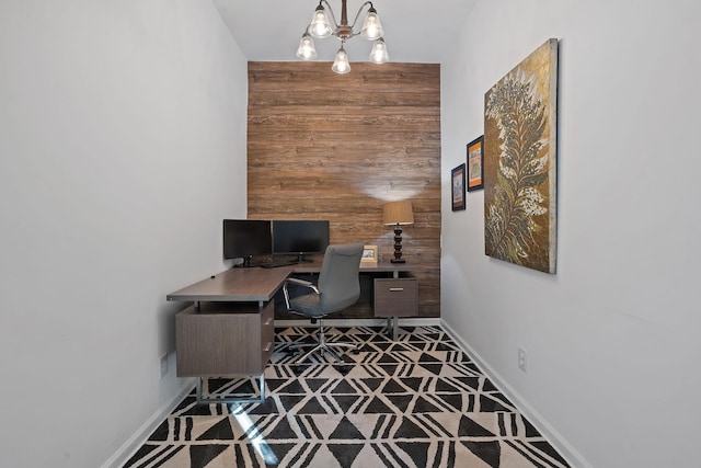 office with wood walls and a notable chandelier