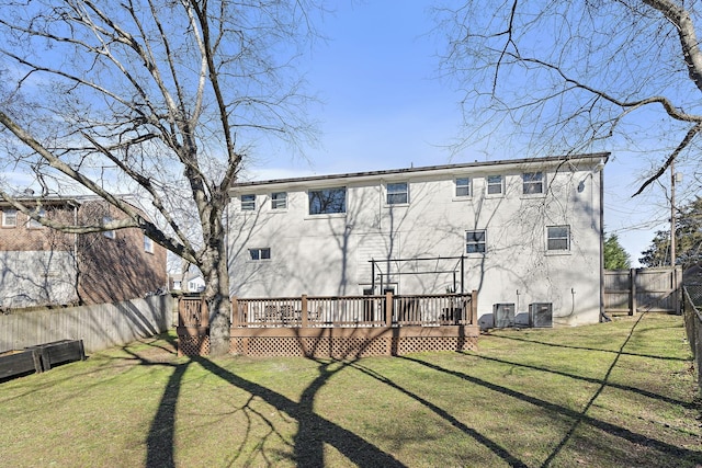 back of house featuring cooling unit, a deck, and a lawn