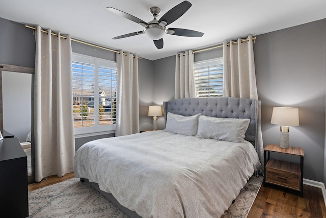 bedroom with ceiling fan and dark hardwood / wood-style flooring