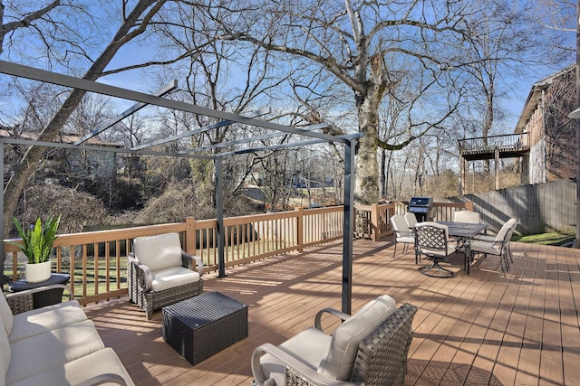 wooden deck with an outdoor hangout area and area for grilling