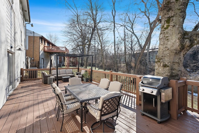 wooden terrace featuring an outdoor living space and area for grilling