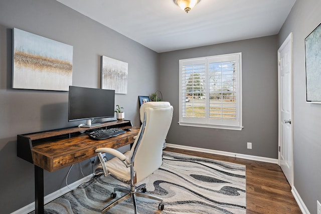 home office with dark hardwood / wood-style floors