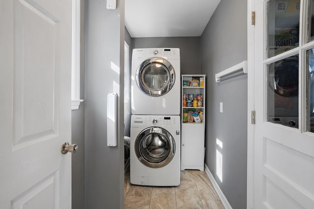 laundry area with stacked washer and clothes dryer