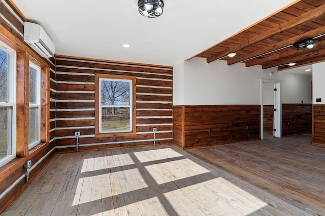 empty room with beamed ceiling, wood ceiling, wooden walls, dark hardwood / wood-style flooring, and a wall mounted AC