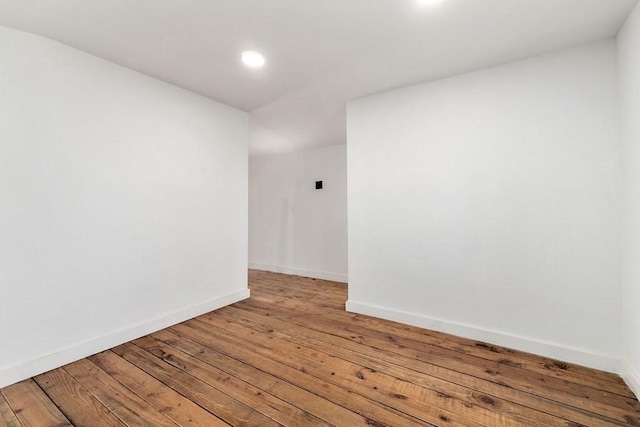 empty room with hardwood / wood-style flooring