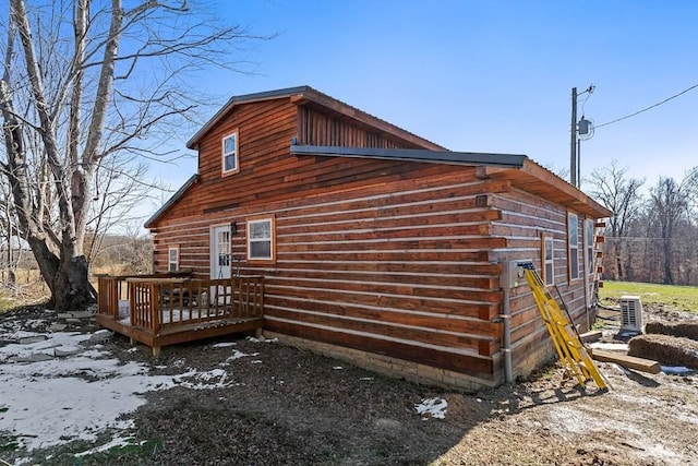 view of home's exterior featuring central air condition unit and a wooden deck