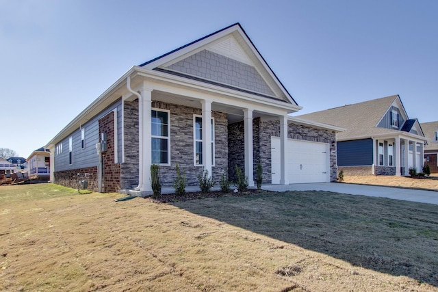 view of front of home featuring a garage, a front yard, and a porch