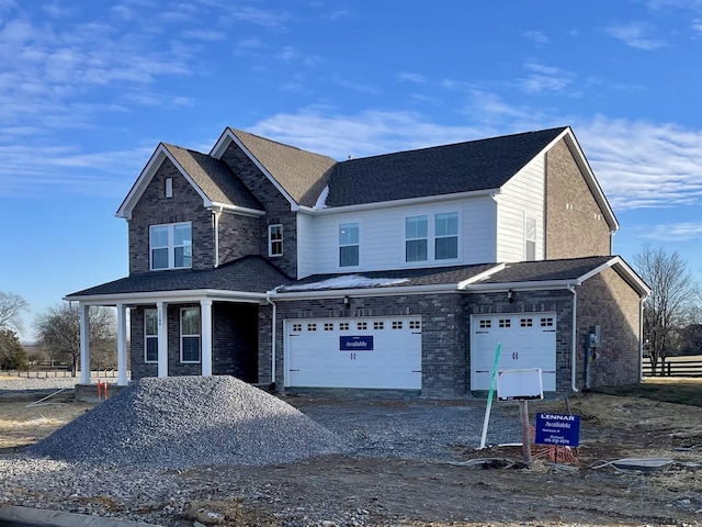 view of front property featuring a garage and covered porch