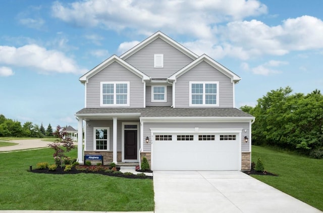 craftsman-style house featuring a garage and a front lawn