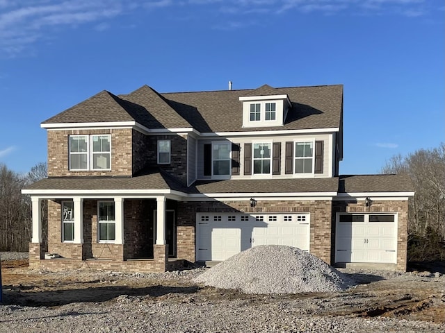 view of front of house with a garage and a porch